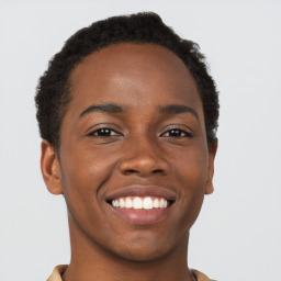 Joyful black young-adult male with short  brown hair and brown eyes