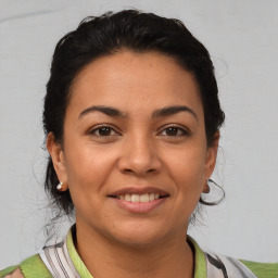 Joyful latino young-adult female with short  brown hair and brown eyes