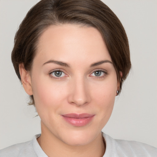 Joyful white young-adult female with medium  brown hair and grey eyes