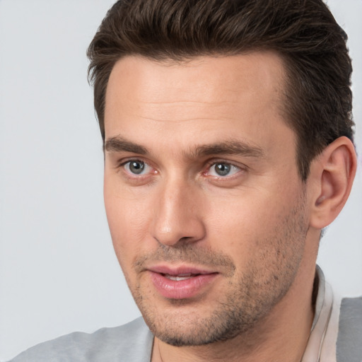 Joyful white young-adult male with short  brown hair and brown eyes