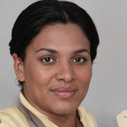 Joyful latino young-adult female with short  brown hair and brown eyes