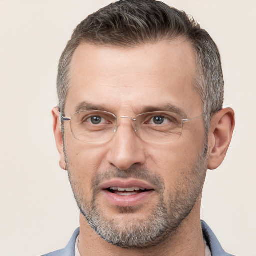 Joyful white adult male with short  brown hair and brown eyes