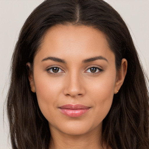 Joyful latino young-adult female with long  brown hair and brown eyes