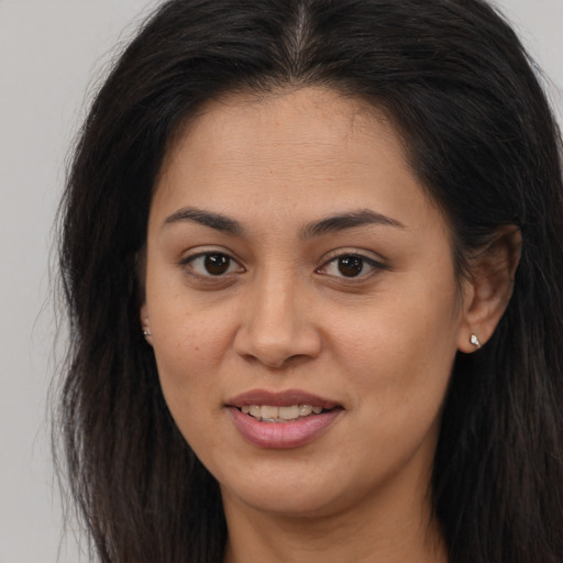 Joyful latino young-adult female with long  brown hair and brown eyes