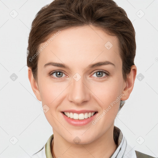 Joyful white young-adult female with short  brown hair and grey eyes