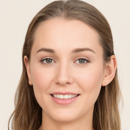 Joyful white young-adult female with long  brown hair and blue eyes