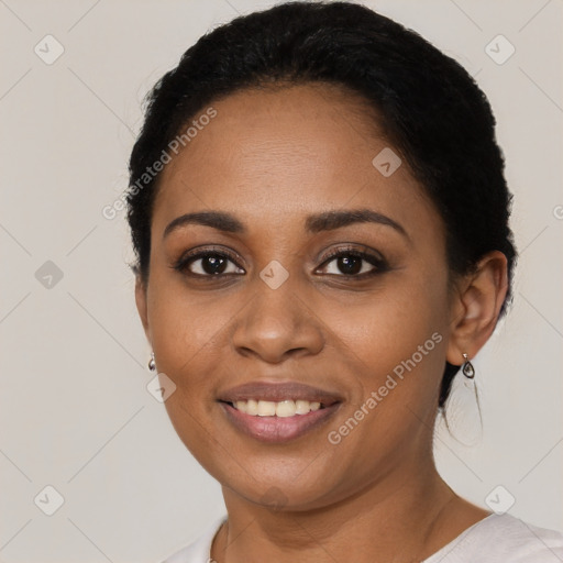 Joyful black young-adult female with short  black hair and brown eyes