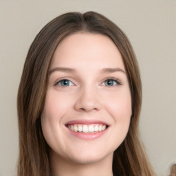 Joyful white young-adult female with long  brown hair and blue eyes