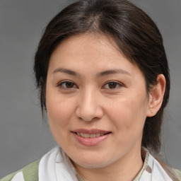 Joyful white adult female with medium  brown hair and brown eyes