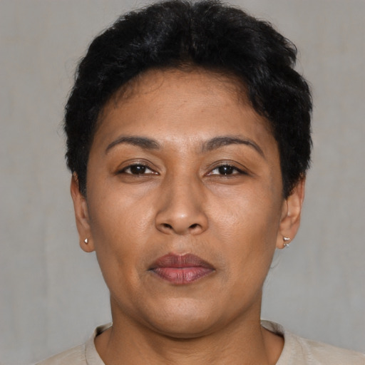 Joyful latino adult female with short  brown hair and brown eyes