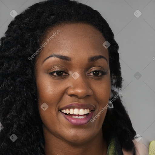 Joyful black young-adult female with long  brown hair and brown eyes