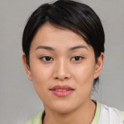 Joyful asian young-adult female with short  brown hair and brown eyes