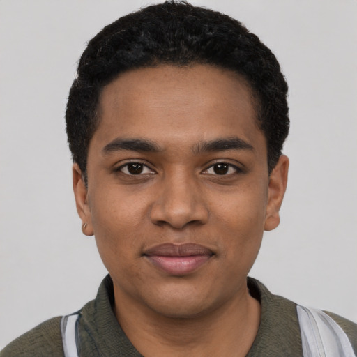 Joyful black young-adult male with short  black hair and brown eyes