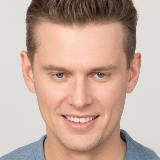 Joyful white adult male with short  brown hair and brown eyes