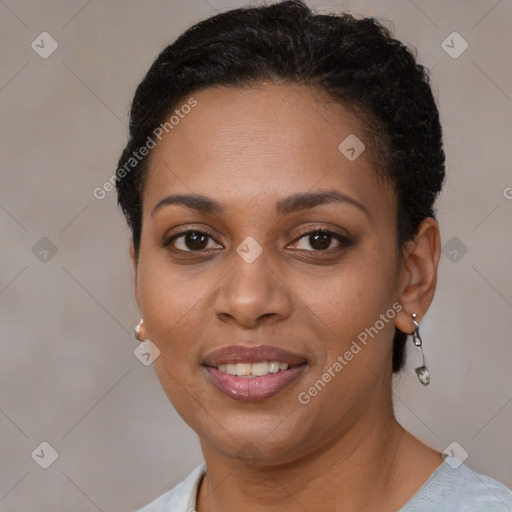 Joyful black young-adult female with short  brown hair and brown eyes