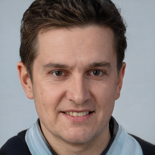 Joyful white adult male with short  brown hair and brown eyes