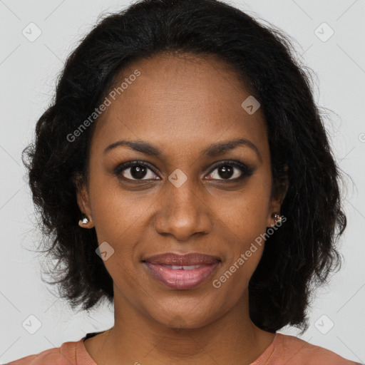 Joyful black young-adult female with long  brown hair and brown eyes