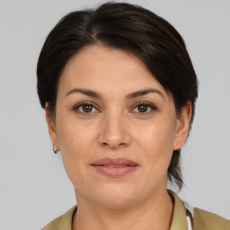 Joyful white adult female with medium  brown hair and brown eyes