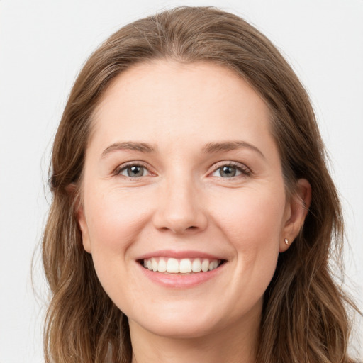 Joyful white young-adult female with long  brown hair and grey eyes