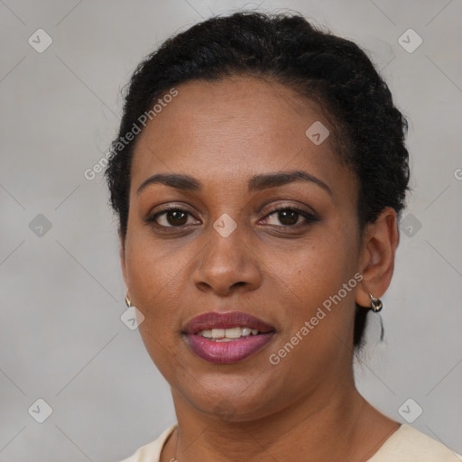 Joyful black adult female with short  brown hair and brown eyes