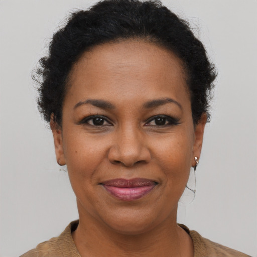 Joyful black adult female with short  brown hair and brown eyes