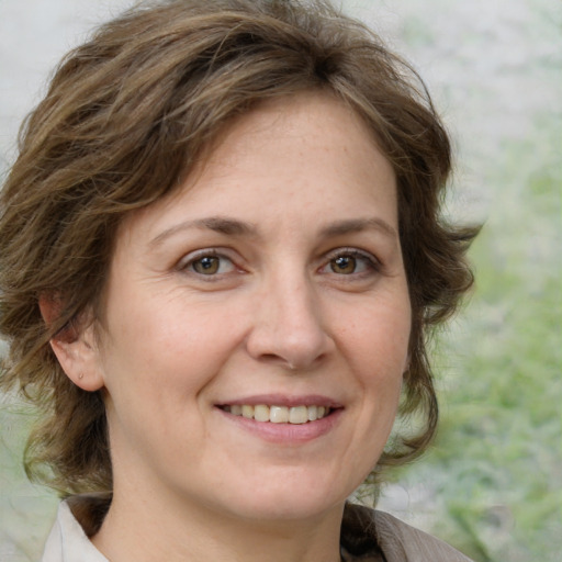 Joyful white adult female with medium  brown hair and grey eyes