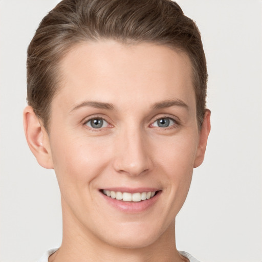 Joyful white young-adult female with short  brown hair and grey eyes