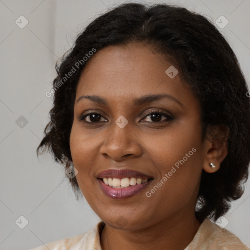 Joyful black young-adult female with medium  brown hair and brown eyes