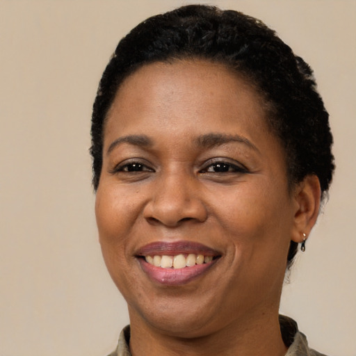 Joyful latino adult female with short  brown hair and brown eyes