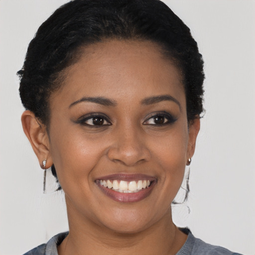 Joyful latino young-adult female with short  brown hair and brown eyes