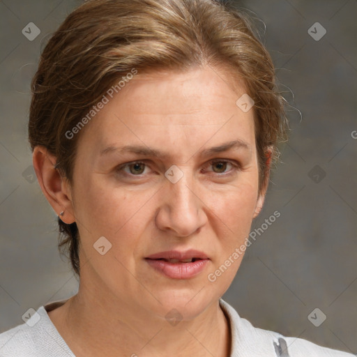 Joyful white adult female with medium  brown hair and grey eyes