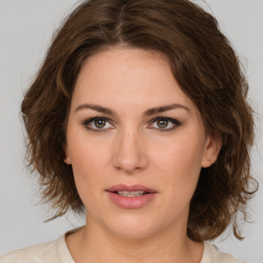 Joyful white young-adult female with medium  brown hair and green eyes