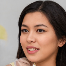 Joyful asian young-adult female with long  brown hair and brown eyes