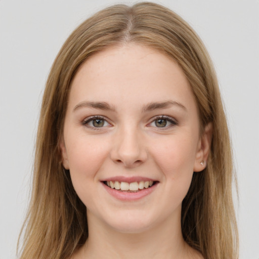 Joyful white young-adult female with long  brown hair and green eyes