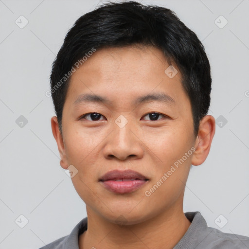 Joyful asian young-adult male with short  black hair and brown eyes