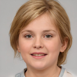 Joyful white child female with medium  brown hair and grey eyes