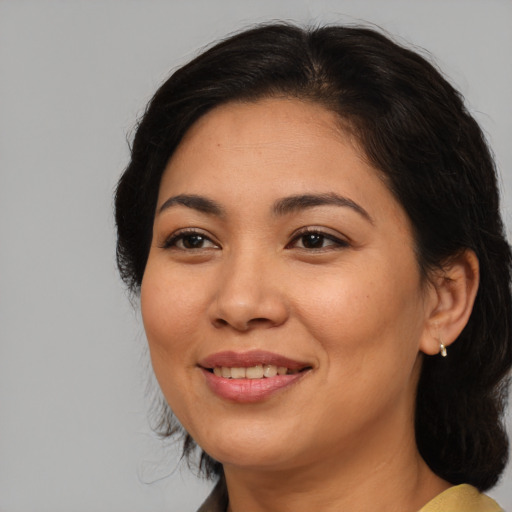 Joyful asian adult female with medium  brown hair and brown eyes