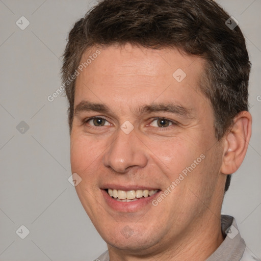 Joyful white adult male with short  brown hair and brown eyes