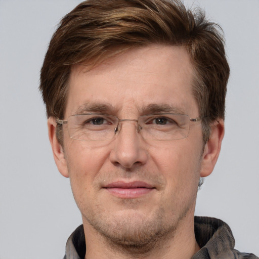 Joyful white adult male with short  brown hair and grey eyes