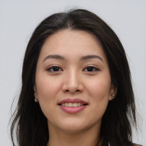 Joyful asian young-adult female with long  brown hair and brown eyes