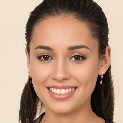 Joyful white young-adult female with long  brown hair and brown eyes