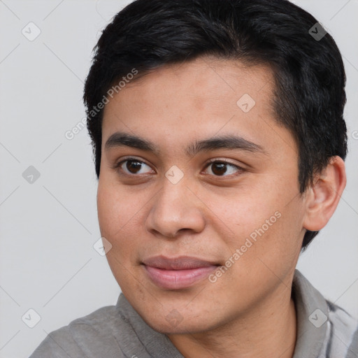 Joyful white young-adult male with short  black hair and brown eyes