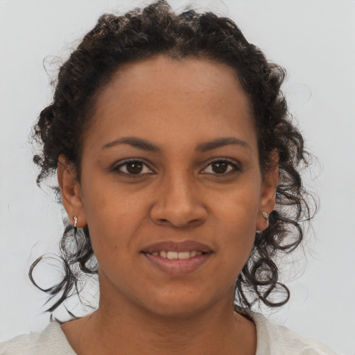 Joyful black young-adult female with short  brown hair and brown eyes