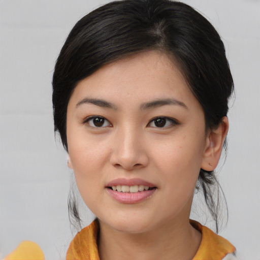 Joyful asian young-adult female with medium  black hair and brown eyes
