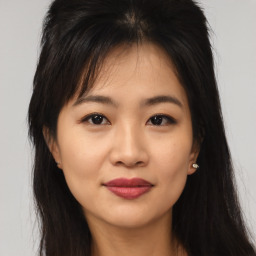 Joyful asian young-adult female with long  brown hair and brown eyes