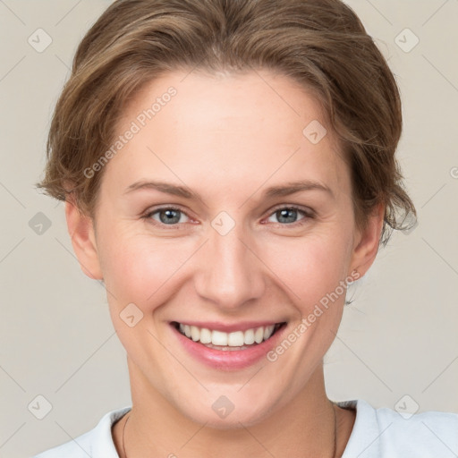 Joyful white young-adult female with short  brown hair and grey eyes