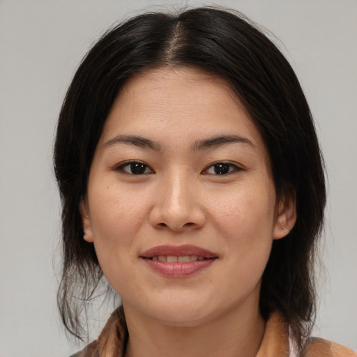 Joyful asian young-adult female with medium  brown hair and brown eyes