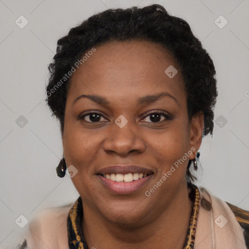 Joyful black adult female with short  black hair and brown eyes