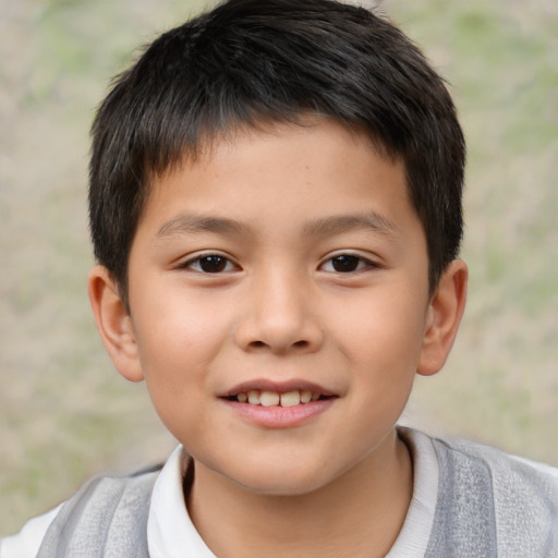 Joyful asian child male with short  brown hair and brown eyes