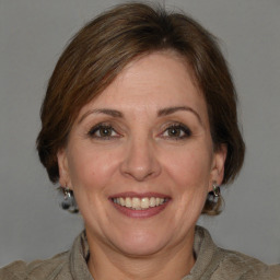 Joyful white adult female with medium  brown hair and grey eyes